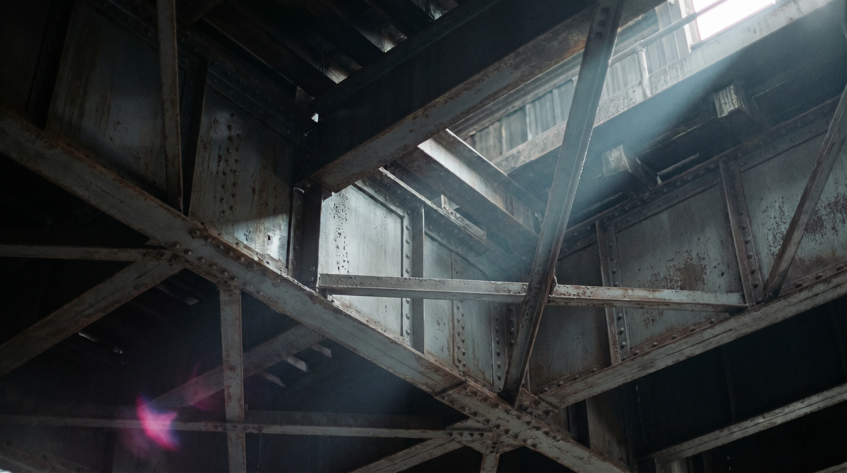 Abstract view looking up through crossing steel girders