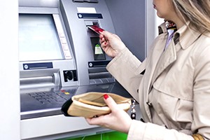 Woman taking money out ofr cash machine